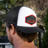 A black/white NCB snapback hat worn backwards